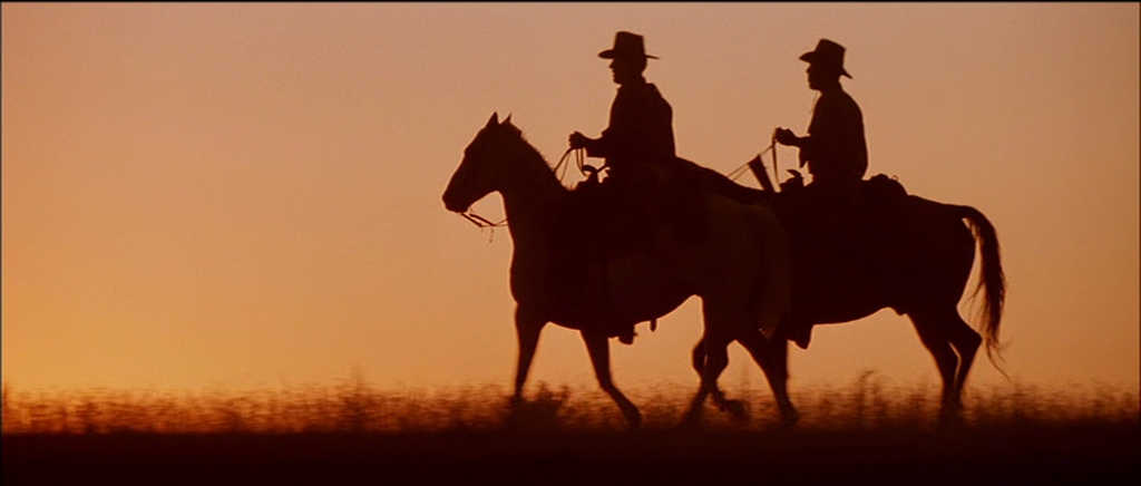 Two riders silhouetted at sunset in Unforgiven