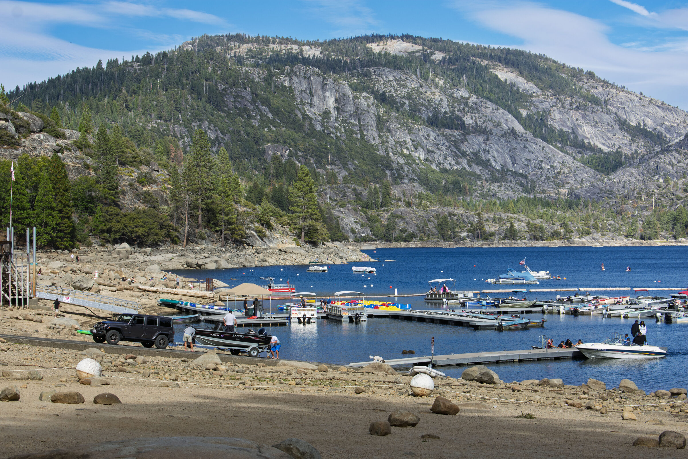The marina and beach at Pinecrest Lake below a granite ridge