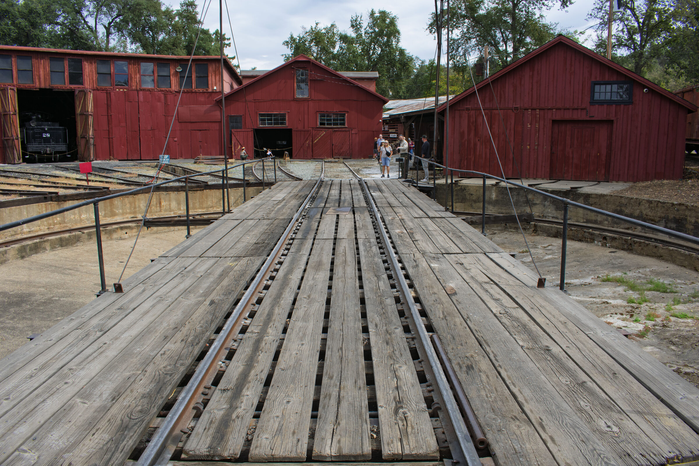 The wooden turntable bridge leading to the red roundhouse at Railtown 1897